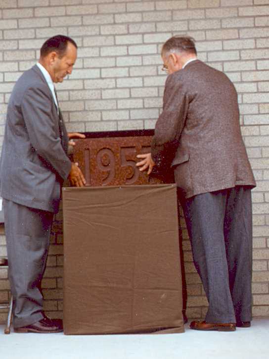 President Herbert Welte, left, and Sherrod E. Skinner, laying cornerstone.