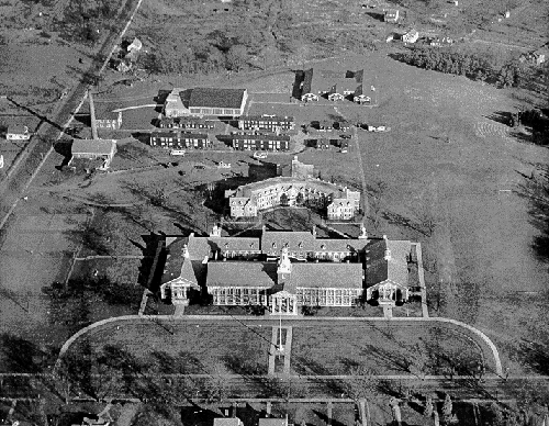 Aerial view photo of the campus from about 1950, 
showing East Hall in the upper right hand corner, WWII barracks just behind Marcus White dormitory, used for 
faculty housing, power plant, Memorial Hall and Administration Building