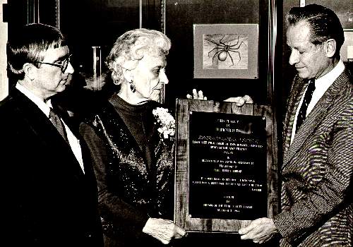 Photograph of, from left to right, Reed Ostrander, President
of the Friends of the Library, Edith Swann, wife of the late Reginald LeGrande Swann and President Don F. James.
Presentation of a plaque honoring the late Professor Swann for his support of the library. December 3, 1984