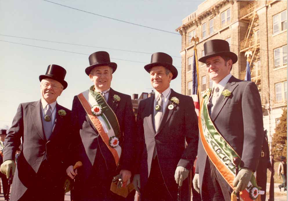 Color 8X10 dated: 3/14/1982
Governor O'Neill and three men outdoors for a parade. Formal Dress, top hats, sashes at St. Patricks Day Parade. New Haven, CT. Left to right: former Mayor of New Haven, Richard C. Lee, Gov. O'Neill, Mayor Dilieto, New Haven, Michael V. Lynch.