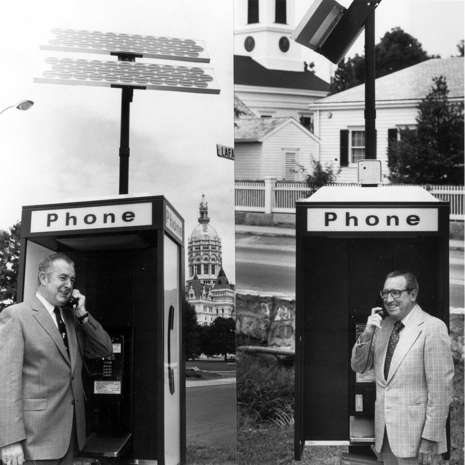 B&W 8X10 dated: 7/23/1982
Governor O'Neill and former Governor Dempsey telephoning each other over a 'solar' telephone by Southern New England Telephone (SNET). Gov. O'Neill is near the capitol, and Gov. Dempsey near Mystic Seaport.